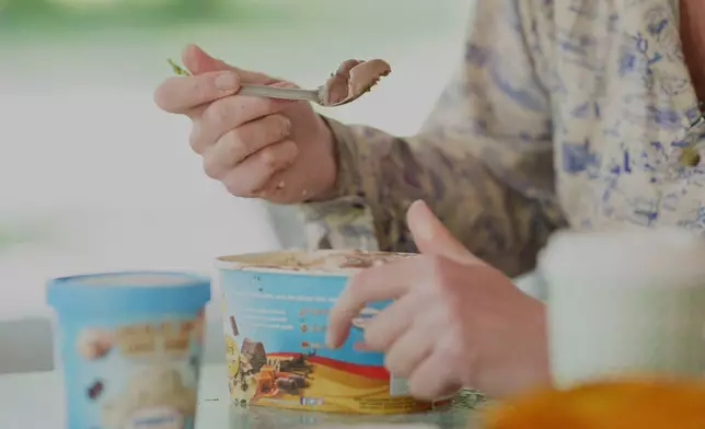 Appalachian Trail thru-hiker Sam Cooper, trail name Pie Top, attempts the half-gallon ice cream challenge at Pine Grove Furnace State Park in Pennsylvania on Tuesday, June 10, 2025. (AP Photo/Mingson Lau)