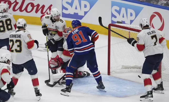Edmonton Oilers' Evander Kane (91) watches as Mattias Ekholm's (not shown) shot gets past Florida Panthers goalie Sergei Bobrovsky (72) for a goal during the third period in Game 1 of the NHL Stanley Cup Final, in Edmonton, on Wednesday, June 4, 2025. (Darryl Dyck/The Canadian Press via AP)