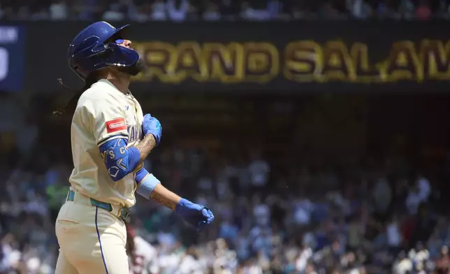 Seattle Mariners' J.P. Crawford rounds the bases on his grand slam off Cleveland Guardians starting pitcher Luis L. Ortiz during the second inning of a baseball game Sunday, June 15, 2025, in Seattle. (AP Photo/John Froschauer)