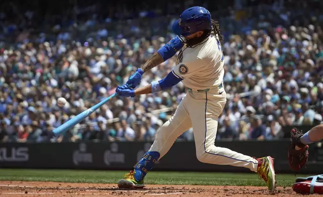 Seattle Mariners' J.P. Crawford hits a grand slam off Cleveland Guardians starting pitcher Luis L. Ortiz during the second inning of a baseball game Sunday, June 15, 2025, in Seattle. (AP Photo/John Froschauer)