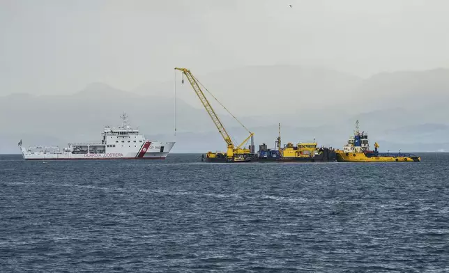 FILE - Italian Coast Guard's Luigi Dattilo patrol boat, left, assists the multi-purpose floating work barge Hebo Lift 2 monitoring the stretch of sea off Porticello, near Palermo, Sicily, Italy, Sunday, May 4, 2025, where the British superyacht Bayesian sunk on August 19, 2024 as the operations for its recovery start. (AP Photo/Salvatore Cavalli, File)