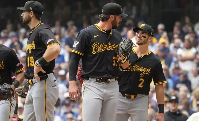 Pittsburgh Pirates, from left, shortstop Jared Triolo, pitcher Paul Skenes and first baseman Spencer Horwitz meet at the mound during the second inning of a baseball game against the Milwaukee Brewers, Wednesday, June 25, 2025, in Milwaukee. (AP Photo/Kayla Wolf)