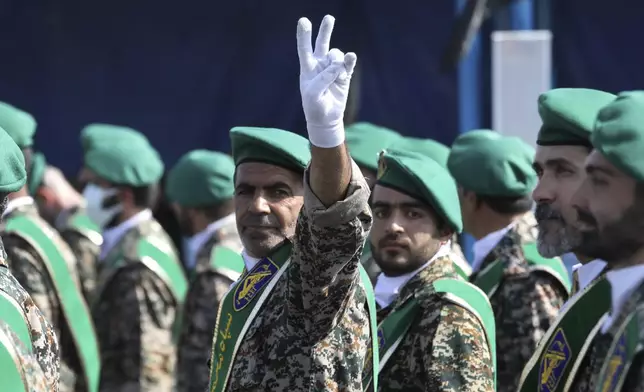 FILE - A member of Iran's Basij paramilitary force flashes a victory sign during a military parade outside of Tehran, Iran, on Sept. 22, 2022. (AP Photo/Vahid Salemi, File)