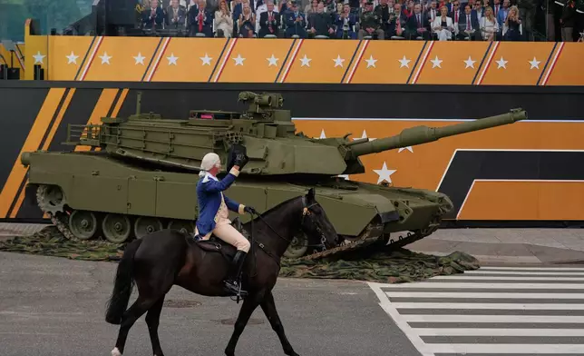 President Donald Trump attends a military parade commemorating the Army's 250th anniversary, coinciding with his 79th birthday, Saturday, June 14, 2025, in Washington. (AP Photo/Julia Demaree Nikhinson)