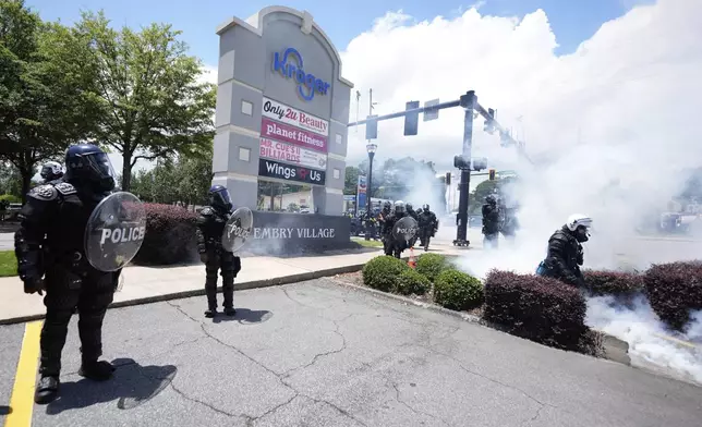 Police break up a crowed during a "No Kings" protest in Dekalb County, near Atlanta, Saturday, June 14, 2025. (AP Photo/Mike Stewart)