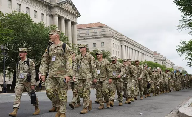 U.S. Army soldiers walking along Constitution Ave., on the National Mall ahead of a parade commemorating the Army's 250th anniversary and coinciding with President Donald Trump's 79th birthday, Saturday, June 14, 2025, in Washington. (AP Photo/Pablo Martinez Monsivais)
