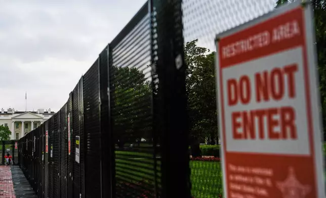 A fence blocks access to the White House ahead of an upcoming military parade commemorating the U.S. Army's 250th anniversary and coinciding with President Donald Trump's 79th birthday, Saturday, June 14, 2025, in Washington (AP Photo/Julia Demaree Nikhinson)
