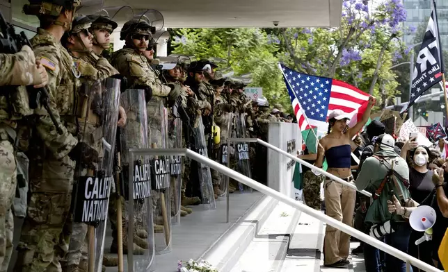 Protesters stand off against California National Guard soldiers at the Federal Building in downtown Los Angeles during a "No Kings" protest on Saturday, June 14, 2025. (AP Photo/Richard Vogel)
