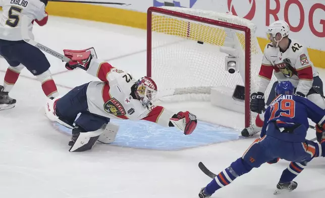 Edmonton Oilers' Leon Draisaitl (29) scores against Florida Panthers goalie Sergei Bobrovsky (72) as Gustav Forsling (42) and Aaron Ekblad (5) watch during the first period in Game 1 of the NHL hockey Stanley Cup final series in Edmonton, Alberta, Wednesday, June 4, 2025. (Darryl Dyck/The Canadian Press via AP)