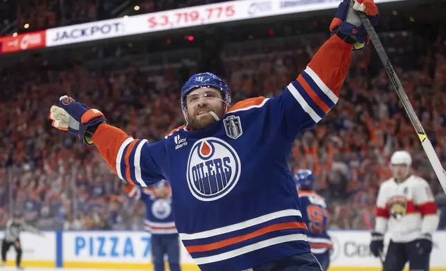 Edmonton Oilers' Leon Draisaitl (29) celebrates his game-winning goal against the Florida Panthers in the first overtime period in Game 1 of the NHL Stanley Cup final in Edmonton, Aberta, Wednesday, June 4, 2025. (Jason Franson/The Canadian Press via AP)