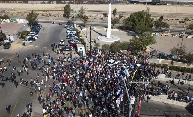 FILE - A group of migrants gather at the Chaparral border crossing in Tijuana, Mexico, Nov. 25, 2018, as the mayor of Tijuana declares a humanitarian crisis in his border city and says that he has asked the United Nations for aid to deal with the approximately 5,000 Central American migrants who have arrived in the city. (AP Photo/Rodrigo Abd, File)