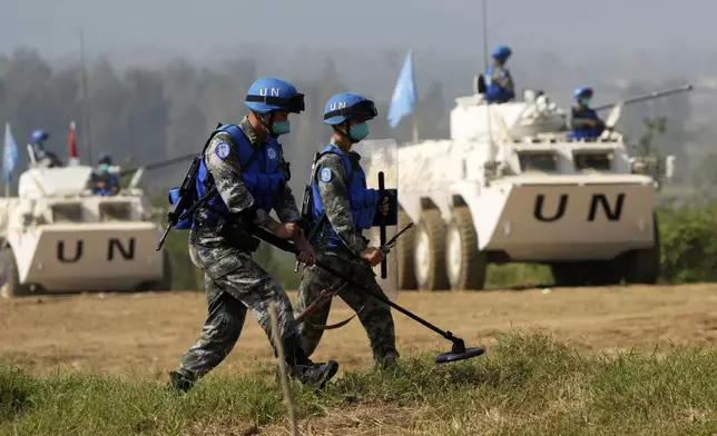 FILE - Chinese United Nations troop practice sweeping for mines during the Shared Destiny 2021 drill at the Queshan Peacekeeping Operation training base in Queshan County in central China's Henan province Sept. 15, 2021. (AP Photo/Ng Han Guan, File)