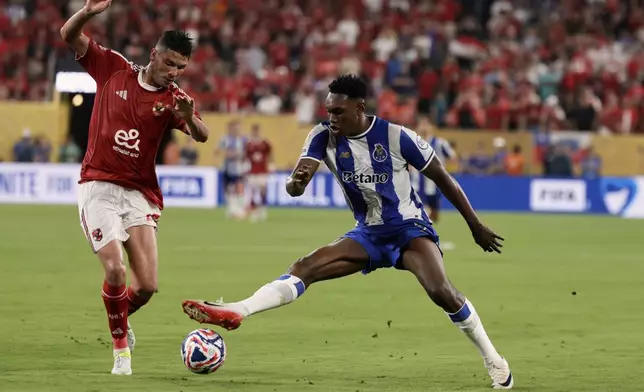 Porto's Samu Aghehowa and Al Ahly's Achraf Dari go after the ball during the Club World Cup Group A soccer match between FC Porto and Al Ahly in East Rutherford, N.J., Monday, June 23, 2025. (AP Photo/Adam Hunger)