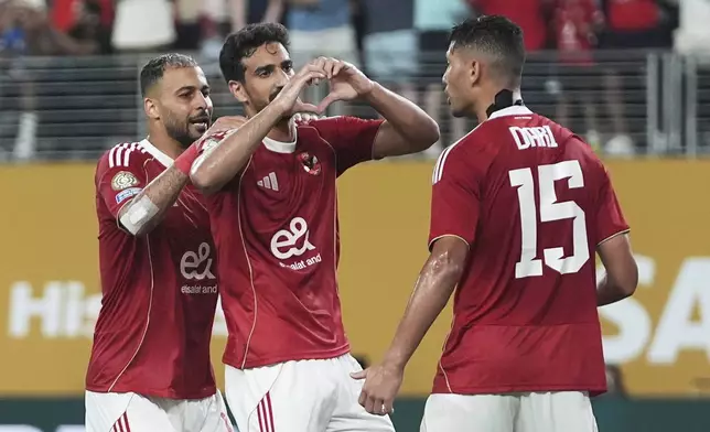 Al Ahly's Mohamed Ali Ben Romdhane, centre, gestures to supporters after scoring his team's fourth goal during the Club World Cup Group A soccer match between FC Porto and Al Ahly in East Rutherford, N.J., Monday, June 23, 2025. (AP Photo/Frank Franklin II)
