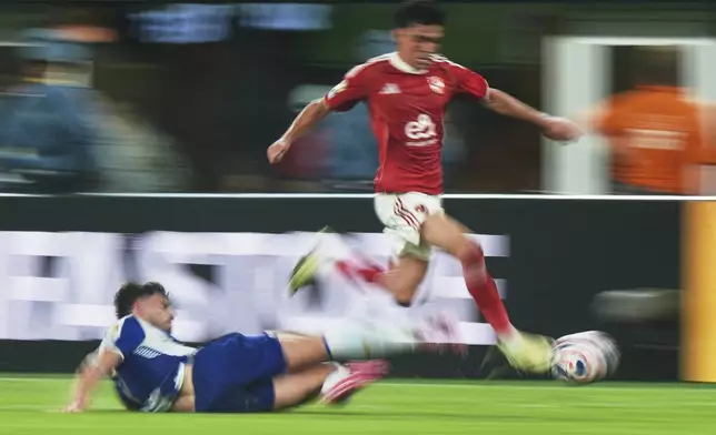 Al Ahly's Achraf Dari is tackled by Porto's Pepe, left, during the Club World Cup Group A soccer match between FC Porto and Al Ahly in East Rutherford, N.J., Monday, June 23, 2025. (AP Photo/Frank Franklin II)