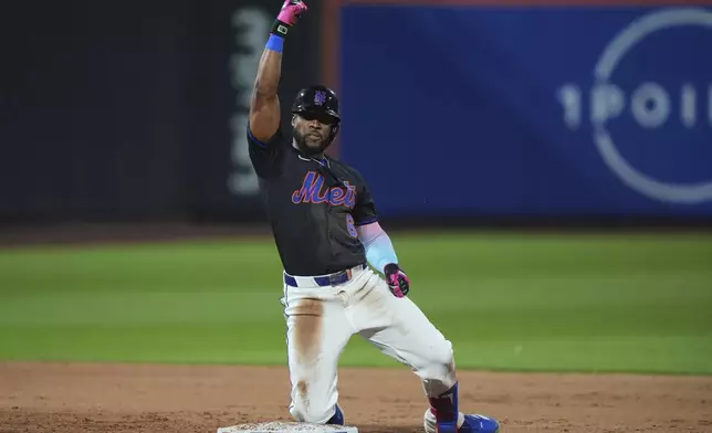 New York Mets' Starling Marte celebrates on second base after hitting a two-run single during the fifth inning during the fifth inning of a baseball game against the Tampa Bay Rays Friday, June 13, 2025, in New York. (AP Photo/Frank Franklin II)