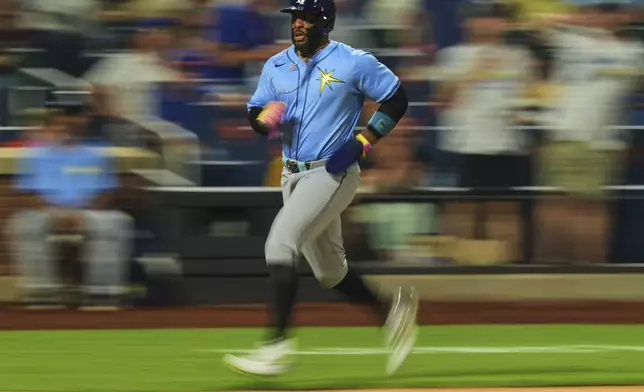 Tampa Bay Rays' Yandy Díaz runs to home plate to score on a single by Jake Mangum during the sixth inning of a baseball game against the New York Mets Friday, June 13, 2025, in New York. (AP Photo/Frank Franklin II)