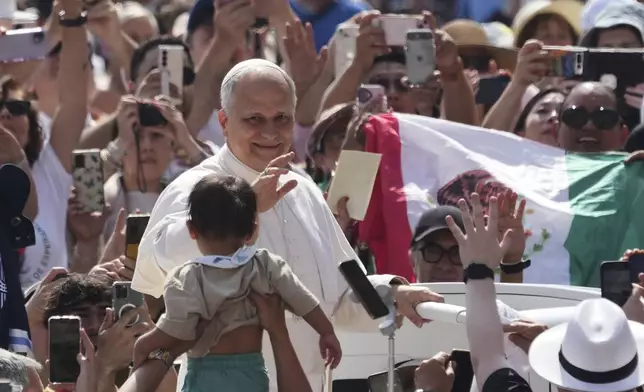 Pope Leo XIV waves as he arrives for his weekly general audience in St. Peter's Square at The Vatican, Wednesday, June 11, 2025. (AP Photo/Andrew Medichini)