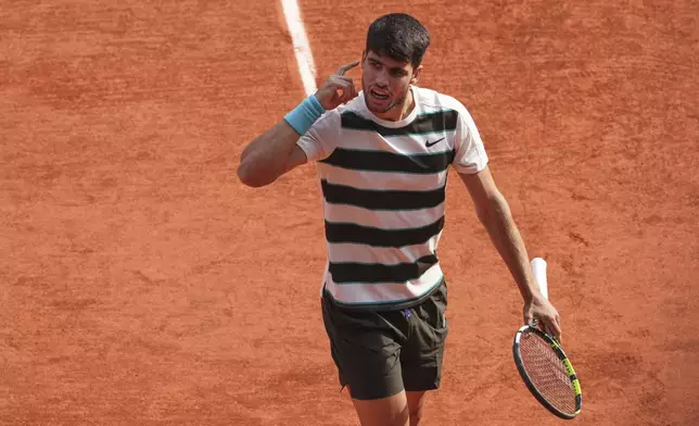 Spain's Carlos Alcaraz reacts as he plays against Italy's Jannik Sinner during their final match of the French Tennis Open at the Roland-Garros stadium in Paris, Sunday, June 8, 2025. (AP Photo/Lindsey Wasson)