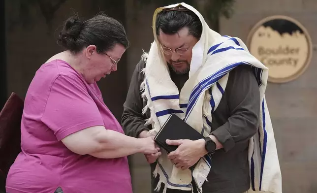 Vickie Gottlieb, left, of Greeley, Colo., joins her husband, Troy, in a prayer for victims of an attack outside of the Boulder County, Colo., courthouse, Monday, June 2, 2025, in Boulder, Colo. (AP Photo/David Zalubowski)