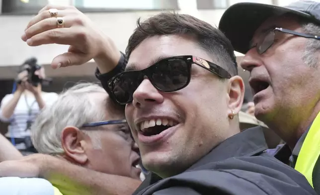 Naoise O Caireallain, a member of the Irish language band Kneecap, arrives at Westminster Magistrates Court in London, Wednesday, June 18, 2025, to support fellow band member Liam Óg Ó hAnnaidh, who is charged with a terrorism offence relating to displaying a flag in support of Hezbollah during a performance with the band in November 2024. (AP Photo/Kin Cheung)