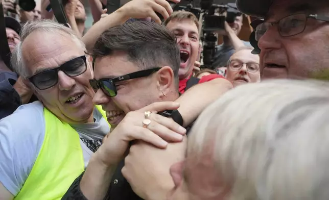 Naoise O Caireallain, a member of the Irish language band Kneecap, arrives at Westminster Magistrates Court in London, Wednesday, June 18, 2025, to support fellow band member Liam Óg Ó hAnnaidh, who is charged with a terrorism offence relating to displaying a flag in support of Hezbollah during a performance with the band in November 2024. (AP Photo/Kin Cheung)
