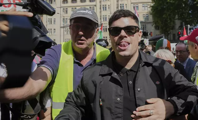 Naoise O Caireallain, a member of the Irish language band Kneecap, arrives at Westminster Magistrates Court in London, Wednesday, June 18, 2025, to support fellow band member Liam Óg Ó hAnnaidh, who is charged with a terrorism offence relating to displaying a flag in support of Hezbollah during a performance with the band in November 2024. (AP Photo/Kin Cheung)
