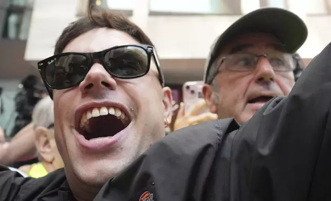 Naoise O Caireallain, a member of the Irish language band Kneecap, arrives at Westminster Magistrates Court in London, Wednesday, June 18, 2025, to support fellow band member Liam Óg Ó hAnnaidh, who is charged with a terrorism offence relating to displaying a flag in support of Hezbollah during a performance with the band in November 2024. (AP Photo/Kin Cheung)