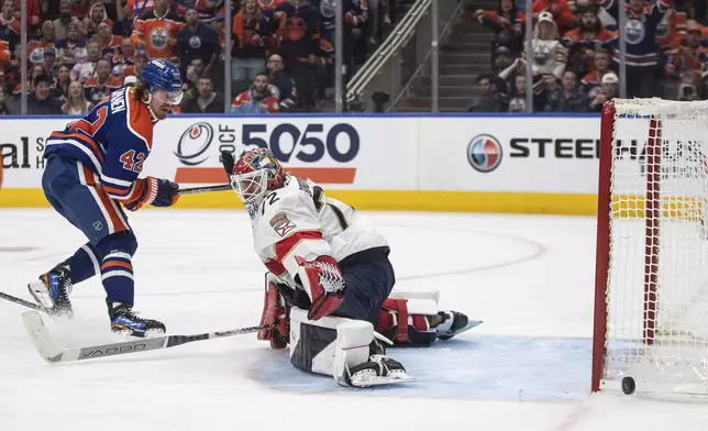 Florida Panthers goalie Sergei Bobrovsky (72) makes the save on Edmonton Oilers' Kasperi Kapanen (42) during the first overtime period in Game 1 of the NHL Stanley Cup final in Edmonton, Alberta, Wednesday, June 4, 2025. (Jason Franson/The Canadian Press via AP)