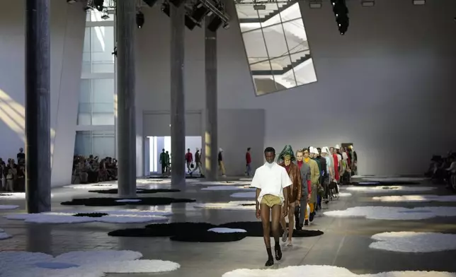 Models wear creations as part of the men's Prada Spring-Summer 2026 collection, that was presented in Milan, Italy, Sunday, June 22, 2025. (AP Photo/Luca Bruno)
