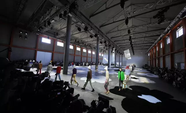 Models wear creations as part of the men's Prada Spring-Summer 2026 collection, that was presented in Milan, Italy, Sunday, June 22, 2025. (AP Photo/Luca Bruno)