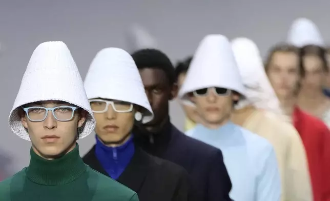 Models wear creations as part of the men's Prada Spring-Summer 2026 collection, that was presented in Milan, Italy, Sunday, June 22, 2025. (AP Photo/Luca Bruno)