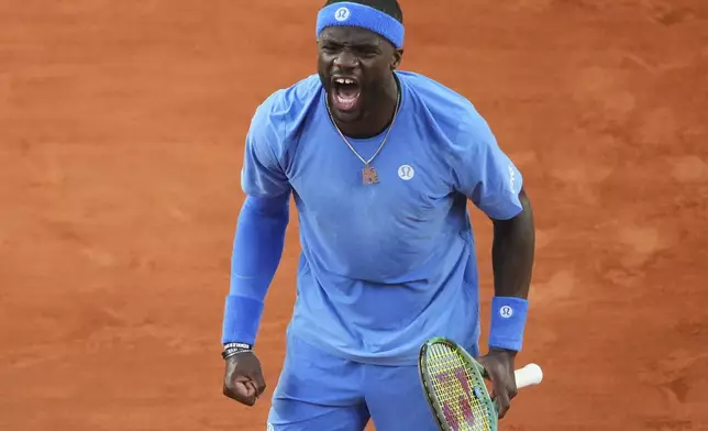 Frances Tiafoe of the U.S. celebrates beating Germany's Daniel Altmaier during their fourth round match of the French Tennis Open, at the Roland-Garros stadium, in Paris, Sunday, June 1 2025. (AP Photo/Lindsey Wasson)