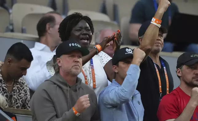 Alphina Tamara, top left, mother of Frances Tiafoe, celebrates his son's win over Germany's Daniel Altmaier during their fourth round match of the French Tennis Open, at the Roland-Garros stadium, in Paris, Sunday, June 1 2025. (AP Photo/Lindsey Wasson)