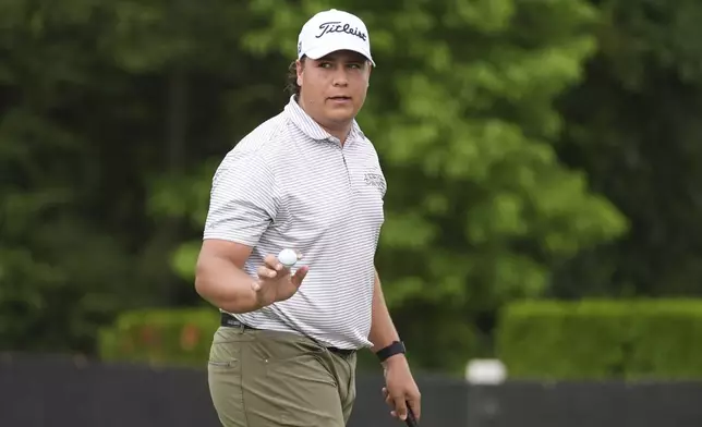 Aldrich Potgieter, of South Africa, waves after his putt on the ninth hole during the first round of the Rocket Classic golf tournament at the Detroit Golf Club, Thursday, June 26, 2025, in Detroit. (AP Photo/Paul Sancya)