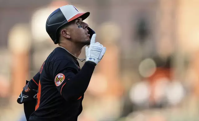 Baltimore Orioles' Ramon Urias reacts after hitting a two-run home run during the third inning of a baseball game against the Detroit Tigers, Wednesday, June 11, 2025, in Baltimore. (AP Photo/Stephanie Scarbrough)