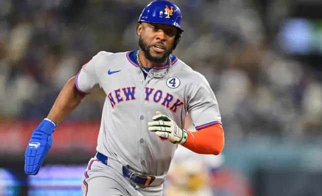 New York Mets' Starling Marte scores on a single by Mets' Francisco Lindor in the tenth inning of a baseball game against the Los Angeles Dodgers, Monday, June 2, 2025, in Los Angeles. (AP Photo/Jayne Kamin-Oncea)