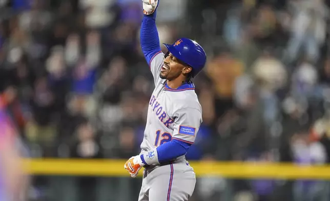 New York Mets pinch-hitter Francisco Lindor gestures to the dugout after reaching second base on a double to drive in two runs off Colorado Rockies relief pitcher Zach Agnos in the ninth inning of a baseball game Friday, June 6, 2025, in Denver. (AP Photo/David Zalubowski)
