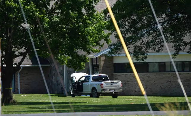 An idle vehicle sits near CrossPointe Community Church in Wayne, Mich., Sunday, June 23, 2025. (AP Photo/Paul Sancya)