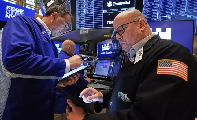 Traders Christopher Lagana, left, and Jeffrey Vazquez work on the floor of the New York Stock Exchange, Thursday, May 29, 2025. (AP Photo/Richard Drew)