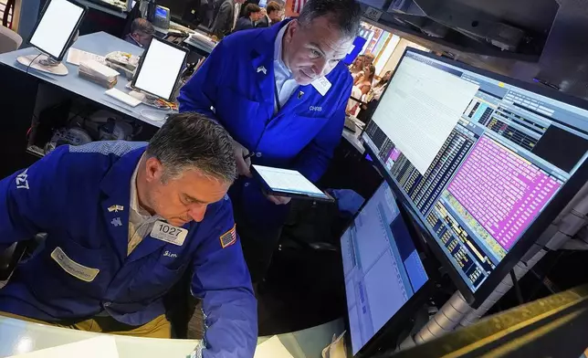Traders James Bodner, left, and Chris Lagana work on the floor of the New York Stock Exchange, Tuesday, June 3, 2025. (AP Photo/Richard Drew)