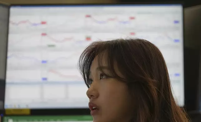 A dealer watches computer monitors at a dealing room of Hana Bank in Seoul, South Korea, Monday, June 2, 2025. (AP Photo/Lee Jin-man)