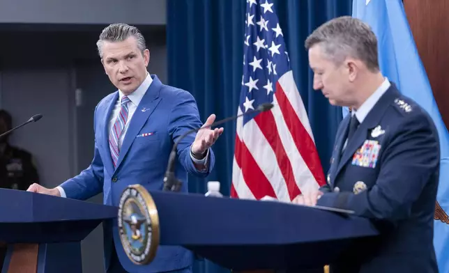 Defense Secretary Pete Hegseth, left, speaks at a news conference with Joint Chiefs Chairman Gen. Dan Caine at the Pentagon, Thursday, June 26, 2025 in Washington. (AP Photo/Kevin Wolf)