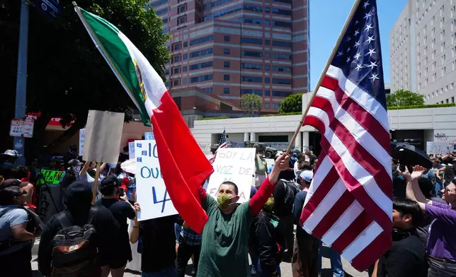 Protesters gather to denounce ICE, U.S Immigration and Customs Enforcement, operations Tuesday, June 10, 2025, in Los Angeles. (AP Photo Damian Dovarganes)