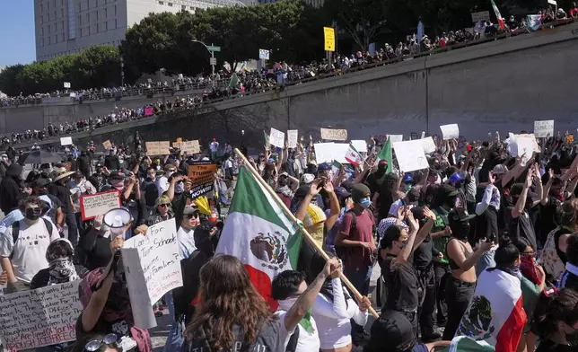 Protesters block the 101 Freeway near the metropolitan detention center of downtown Los Angeles, Sunday, June 8, 2025, following last night's immigration raid protest. (AP Photo/Jae Hong)