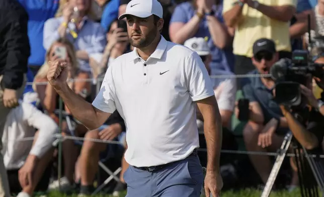 Scottie Scheffler pumps his fist after his putt on the 18th green as he wins the Memorial golf tournament Sunday, June 1, 2025, in Dublin, Ohio. (AP Photo/Sue Ogrocki)