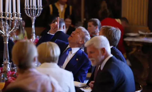 President Donald Trump, center, speaks with Netherland's King Willem Alexander during a dinner at the Paleis Huis ten Bosch ahead of the NATO summit in The Hague, Netherlands, Tuesday, June 24, 2025. (Remko de Waal, Pool Photo via AP)