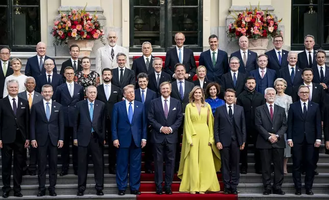 US President Donald Trump, center left, along with the King Willem-Alexander and Queen Maxima of the Netherlands, center, poses for a family photo at the 2025 NATO summit in The Hague, on Tuesday, June 24, 2025. (Haiyun Jiang/Pool Photo via AP)