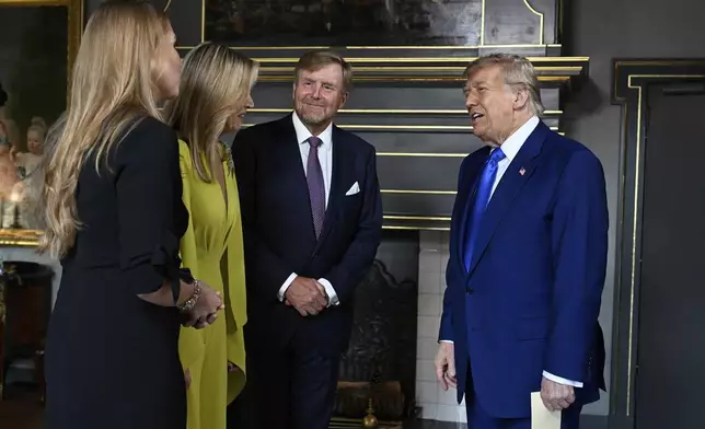 President Donald Trump, right, is welcomed by Netherland's King Willem Alexander, Netherland's Queen Maxima and Netherland's Crown Princess Amalia as he arrives for a formal dinner at the Paleis Huis ten Bosch ahead of the NATO summit in The Hague, Netherlands, Tuesday, June 24, 2025. (Misha Schoemakers, Pool Photo via AP)