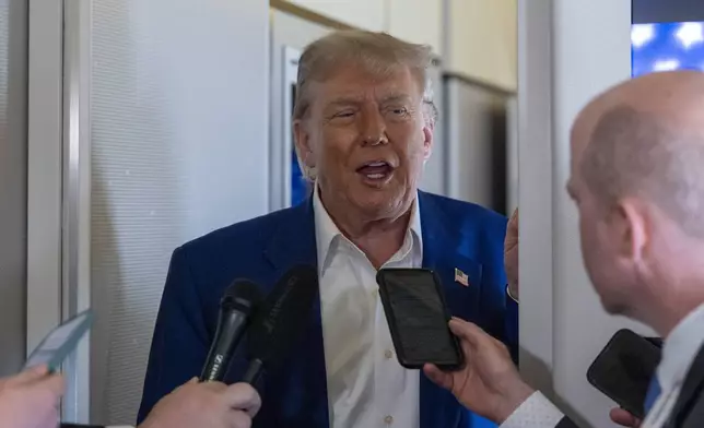 President Donald Trump speaks with reporters on Air Force One while in flight from Joint Base Andrews, Md., to Amsterdam, Netherlands, Tuesday, June 24, 2025. (AP Photo/Alex Brandon)
